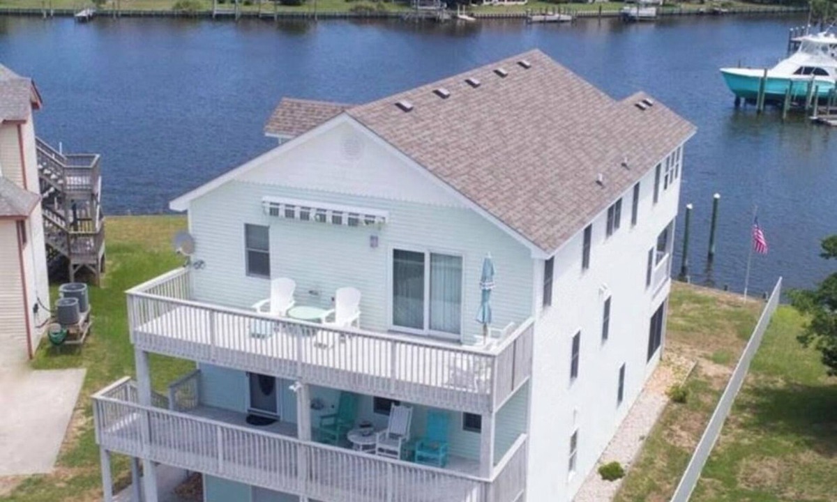 Colington Harbour House | Canal Front Home with Private Dock, Multiple Decks & Hot Tub