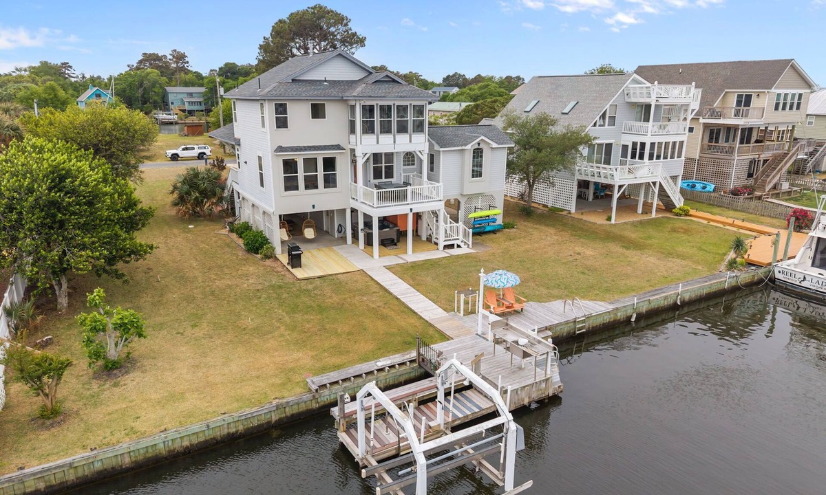 Colington Harbour House | Canal-Front OBX Home w/Dock + Hot Tub/Kayaks/Paddleboards + Bring Your Boat!