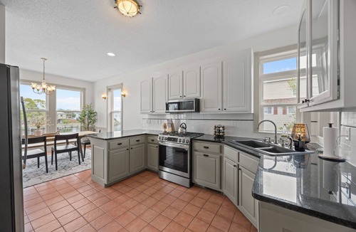 Colington Harbour House | Canal-Front OBX Home w/Dock + Hot Tub/Kayaks/Paddleboards + Bring Your Boat!