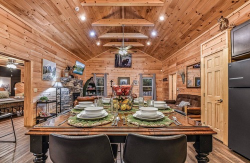 Sevierville Cabin | Creekside 2BR cabin near Pigeon Forge with firepit, WiFi, EV charger, and pet-friendly charm.