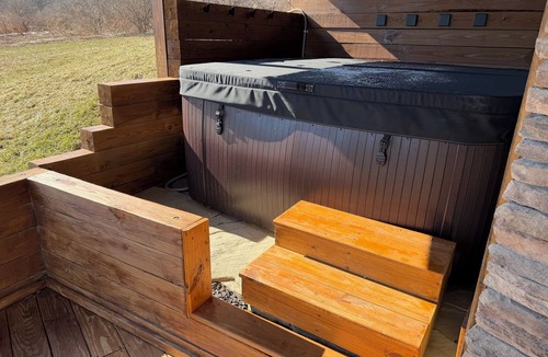 Swain House | Enjoy an updated classic log cabin with ski slope views from the hot tub.