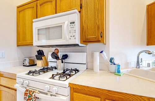 Oak Harbor House | Peek-a-boo ocean view home with outdoor living space, W/D, and balcony
