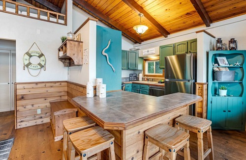 Rockaway Beach Cabin | Rustic waterfront woodland lodge with impressive lake views from patio