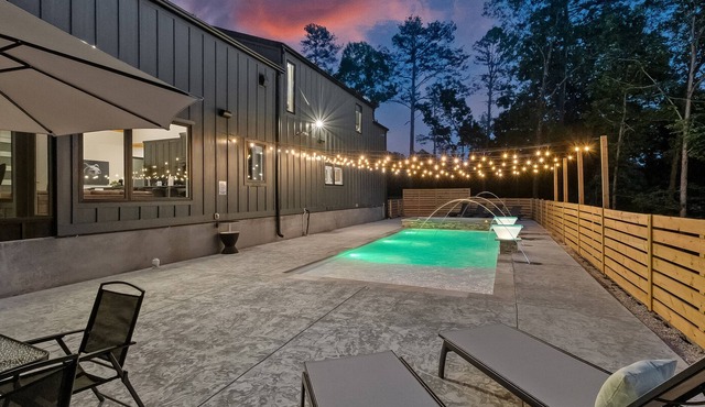 Luxury cabin lined by trees with pool, oversized sunroom, hot tub & grill