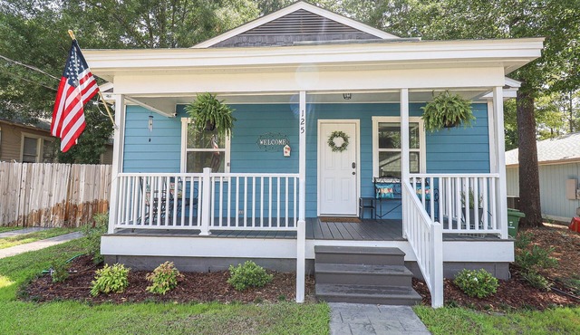 Quaint cottage style home with large fenced yard.