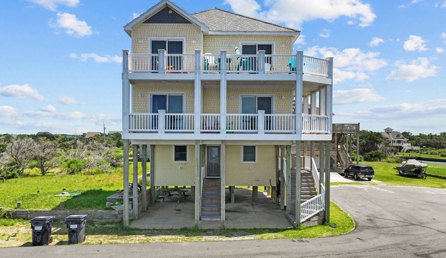 Waterfront home with boat dock, shared pool, & balcony with ocean view